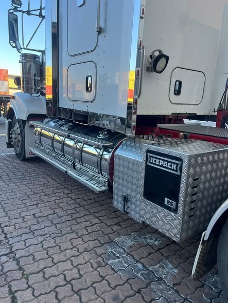 Polished fuel tanks, chequer-plate steps and toolbox on a prime mover