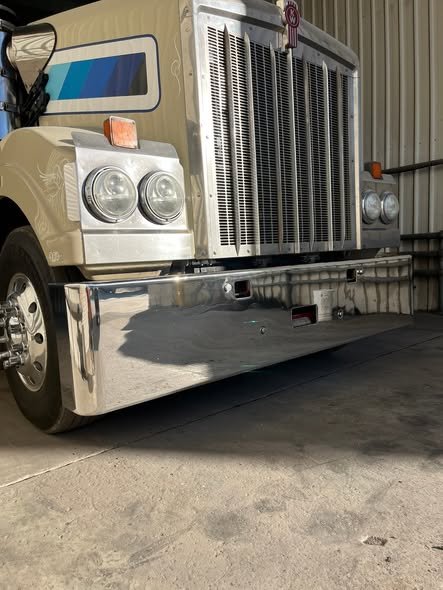 Kenworth with a mirror-polished bumper, grille and alloy rims in a shed