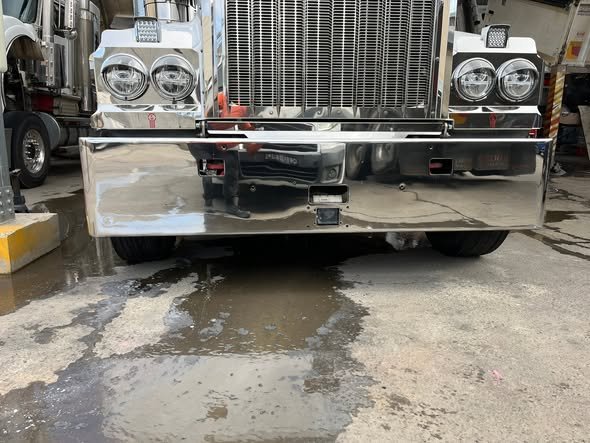 Head-on view of a mirror-polished truck bumper and grille